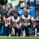 Members of the Houston Texans stand and kneel before the game against the Seattle Seahawks at CenturyLink Field in Seattle on Oct. 29, 2017. (Otto Greule Jr./Getty Images)